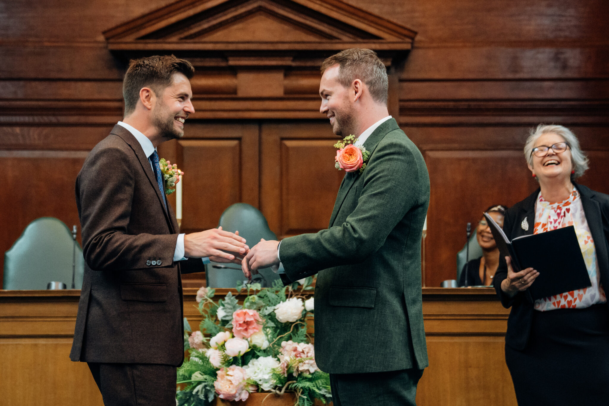 2 grooms exchanging wedding rings at Camden Town Hall